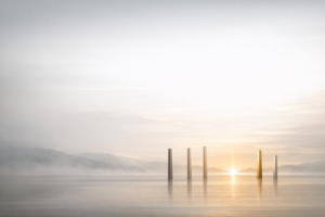 Five pillars rising from calm water at sunrise, representing Sun Tzu's five clarities of purpose, climate, terrain, leadership, and discipline